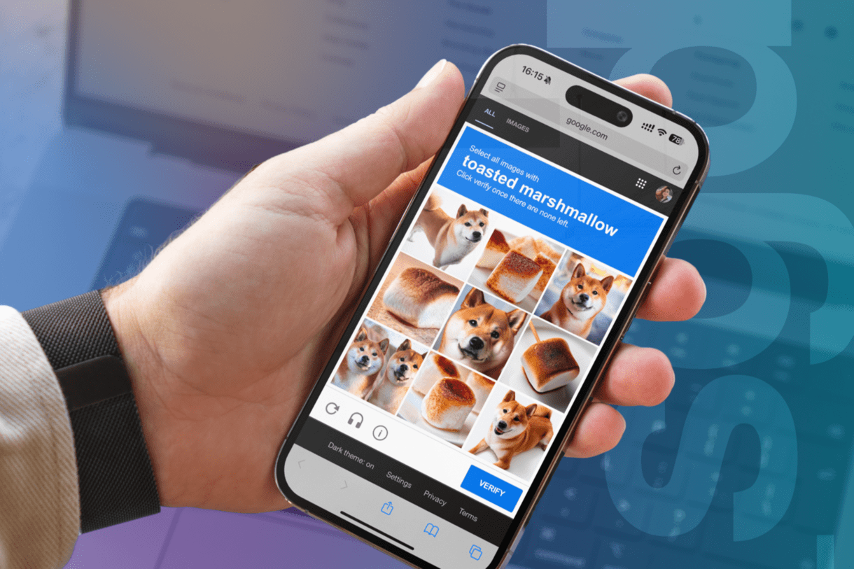 An image of a hand holding a phone with a dog and mallow image in it.